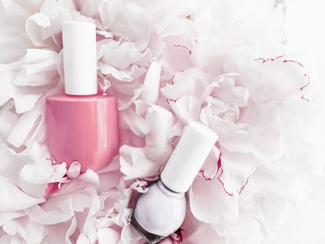 Nail polish bottles on floral background, french manicure and cosmetic branding design