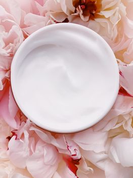 Face cream moisturizer on floral background as luxury skincare cosmetics, healthcare and beauty product concept