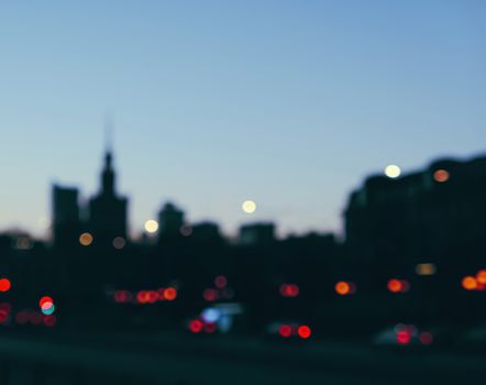 Blurry cityscape silhouette of a European city as background, evening view of Warsaw, Poland