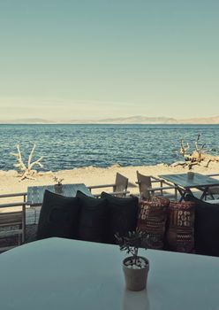 Empty restaurant by the Aegean sea and cruise boat, travel and nature, scene