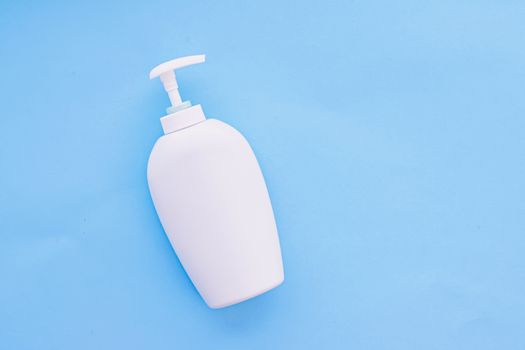 Blank label cosmetic container bottle as product mockup on blue background, hygiene and healthcare