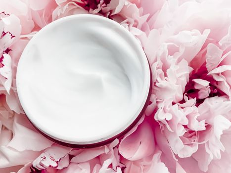 Face cream moisturizer on floral background as luxury skincare cosmetics, healthcare and beauty product concept