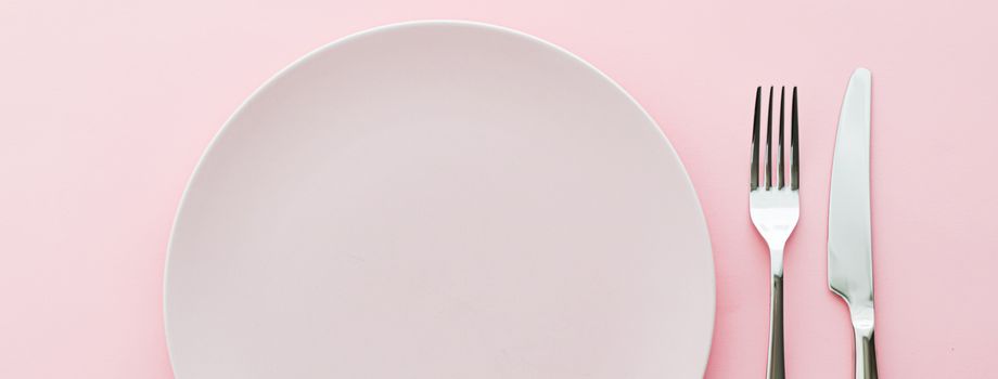 Empty plate and cutlery as mockup set on pink background, top tableware for chef table decor and menu branding design