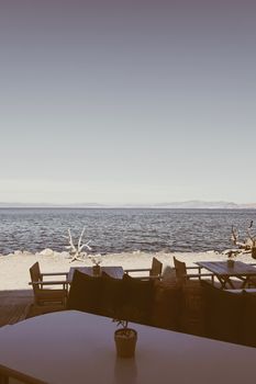 Empty restaurant by the Aegean sea and cruise boat, travel and nature, scene