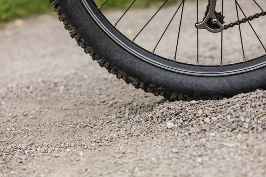 Tealby, Lincolnshire, UK, July 2017, Bike tire kicking up stones