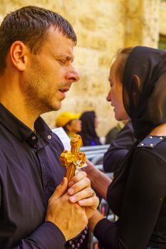 Jerusalem, Israel - April 6, 2018: Orthodox good Friday scene in the entry yard of the church of the holy sepulcher, with pilgrims praying. The old city of Jerusalem, Israel