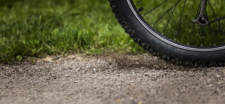 Tealby, Lincolnshire, UK, July 2017, Bike tire kicking up stones