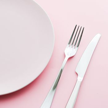 Empty plate and cutlery as mockup set on pink background, top tableware for chef table decor and menu branding design