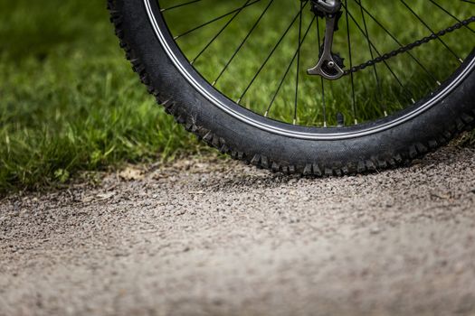 Tealby, Lincolnshire, UK, July 2017, Bike tire kicking up stones