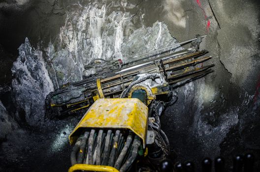 Mining machine arm drilling minerals