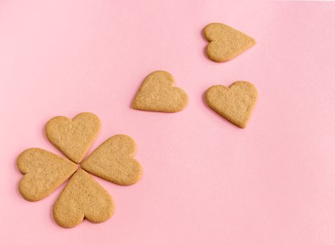 Breakfast. Close-up of heart shaped cookies like a flower petals.. Pink background. Copy space