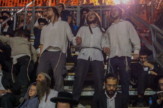 MERON, ISRAEL - MAY 03, 2018: Orthodox Jewish men attend and dance, at the annual hillula of Rabbi Shimon Bar Yochai, in Meron, Israel, on Lag BaOmer Holiday