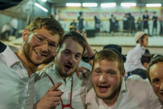 MERON, ISRAEL - MAY 03, 2018: Group of young Jewish orthodox men take part in the annual hillula of Rabbi Shimon Bar Yochai, in Meron, Israel, on Lag BaOmer Holiday