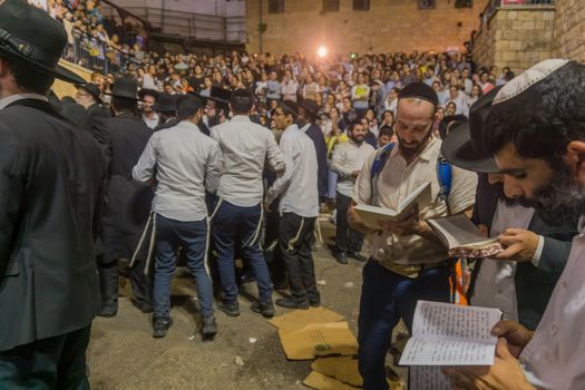 MERON, ISRAEL - MAY 03, 2018: Orthodox Jewish men attend and dance, and women watch, at the annual hillula of Rabbi Shimon Bar Yochai, in Meron, Israel, on Lag BaOmer Holiday