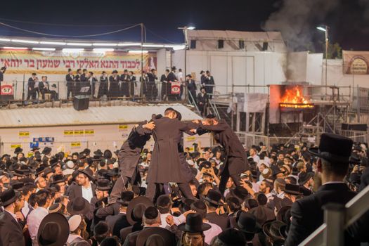 MERON, ISRAEL - MAY 03, 2018: A crowd of orthodox Jews attend and dance, and musicians play, at the annual hillula of Rabbi Shimon Bar Yochai, in Meron, Israel, on Lag BaOmer Holiday
