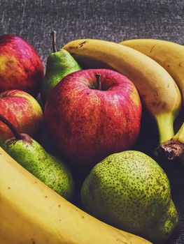 Organic apples, pears and bananas on rustic linen background, fruits farming and agriculture