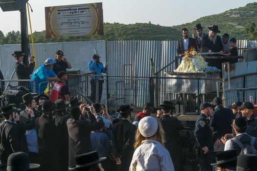 MERON, ISRAEL - MAY 03, 2018: A Breslov Rabbi perform hadlakah (lighting) of ceremonial fire, at the annual hillula of Rabbi Shimon Bar Yochai, in Meron, Israel, on Lag BaOmer Holiday