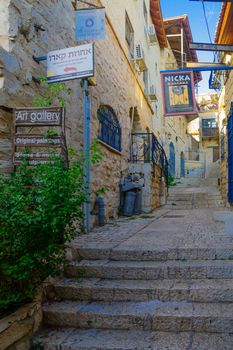 SAFED, ISRAEL - SEPTEMBER 14, 2016: An alley in the Jewish quarter of the old city, with various business signs, in Safed (Tzfat), Israel