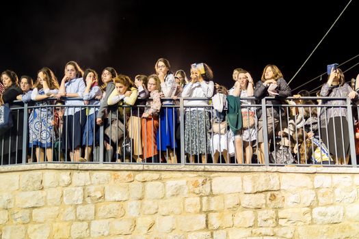 MERON, ISRAEL - MAY 03, 2018: Orthodox Jewish women watch the man only dances, at the annual hillula of Rabbi Shimon Bar Yochai, in Meron, Israel, on Lag BaOmer Holiday