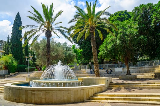HAIFA, ISRAEL - AUGUST 18, 2016: View of Binyamin Garden, with a fountain, locals and visitors, in Hadar HaCarmel district, Haifa, Israel