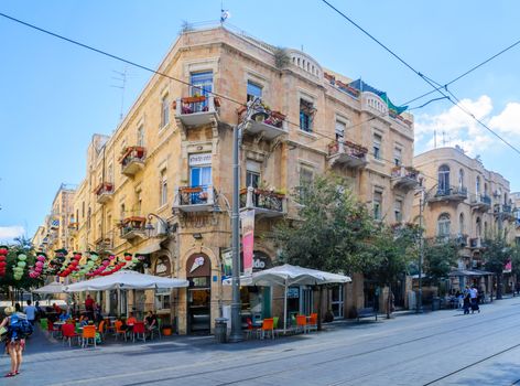 JERUSALEM, ISRAEL - SEPTEMBER 23, 2016: Typical old building in Yafo Street, with local businesses, locals and visitors, in Jerusalem, Israel