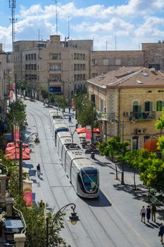 JERUSALEM, ISRAEL - SEPTEMBER 23, 2016: Scene of Yafo Street, with the Generali building, a tram, locals and visitors, in Jerusalem, Israel