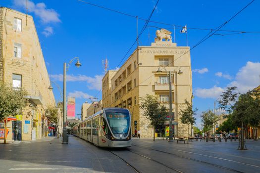 JERUSALEM, ISRAEL - SEPTEMBER 23, 2016: Scene of Yafo Street, with the Generali building, a tram, locals and visitors, in Jerusalem, Israel