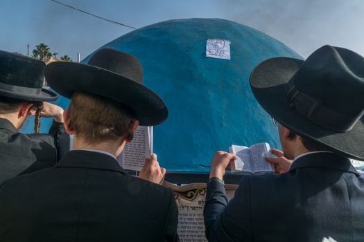 MERON, ISRAEL - MAY 03, 2018 Orthodox Jews pray on the Grave Mark of Rabbi Shimon Bar Yochai, at the annual hillula, in Meron, Israel, on Lag BaOmer Holiday