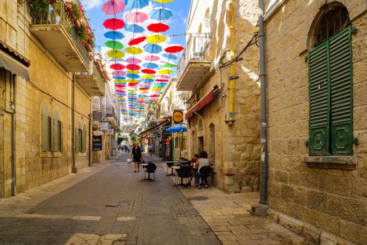 JERUSALEM, ISRAEL - SEPTEMBER 23, 2016: Scene of Yoel Moshe Solomon Street, decorated with colorful umbrellas, with locals and visitors, in the historic Nachalat Shiva district, Jerusalem, Israel