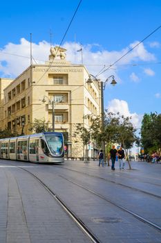 JERUSALEM, ISRAEL - SEPTEMBER 23, 2016: Scene of Yafo Street, with the Generali building, a tram, locals and visitors, in Jerusalem, Israel