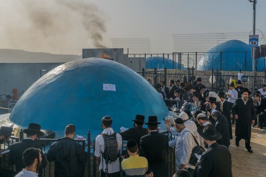 MERON, ISRAEL - MAY 03, 2018 Orthodox Jews pray on the Grave Mark of Rabbi Shimon Bar Yochai, at the annual hillula, in Meron, Israel, on Lag BaOmer Holiday