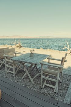 Empty restaurant by the Aegean sea and cruise boat, travel and nature, scene
