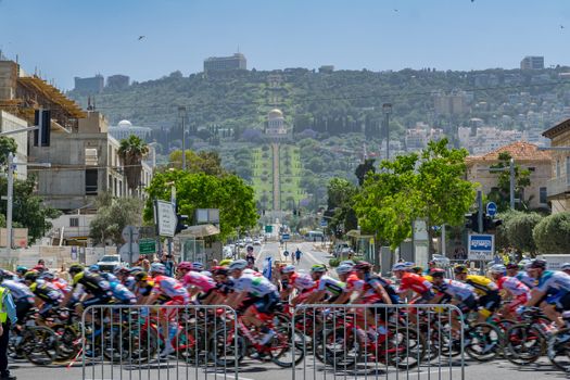 HAIFA, ISRAEL - MAY 05, 2018: Scene of stage 2 of 2018 Giro d Italia, with cyclists and spectators, and the German Colony, Bahai gardens and shrine in the background. Haifa, Israel