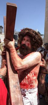 JERUSALEM - APRIL 18, 2014: A group of American actors re-enchant the crucifixion of Jesus Christ along the stations of Via Dolorosa, on Good Friday, in the old city of Jerusalem, Israel