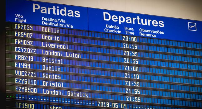 Faro, Portugal - May 3, 2018: billboards departing and arriving aircraft inside the international airport of Faro on a spring day