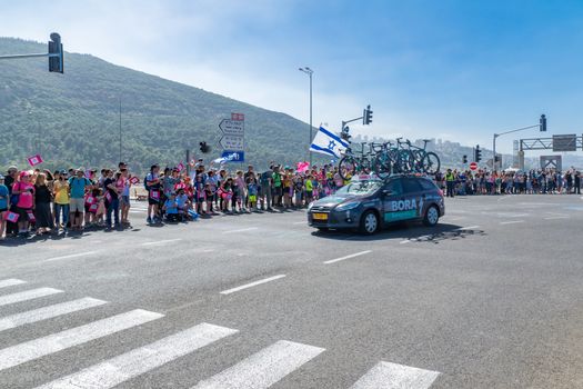YAGUR, ISRAEL - MAY 05, 2018: Scene of stage 2 of 2018 Giro d Italia, with team car and spectators, in Yagur, Israel