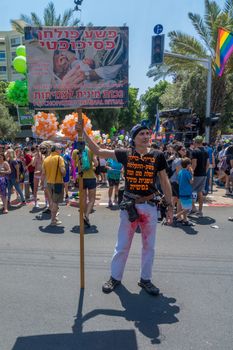 TEL-AVIV, ISRAEL - JUNE 08, 2018: Protestor against circumcision, and other participants, take part in the annual pride parade of the LGBT community, in Tel-Aviv, Israel
