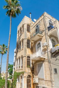 HAIFA, ISRAEL - JUNE 09, 2018: Buildings with a mixture of international (Bauhaus) and Arabic styles, with locals, in Hadar HaCarmel neighborhood, Haifa, Israel