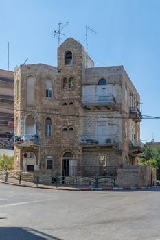 HAIFA, ISRAEL - JUNE 09, 2018: Buildings with a mixture of international (Bauhaus) and Arabic styles, with locals, in Hadar HaCarmel neighborhood, Haifa, Israel