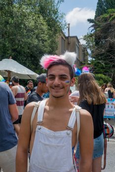 HAIFA, ISRAEL - JUNE 22, 2018: Portrait of a participant, and others in the background, in the annual pride parade of the LGBT community, in Haifa, Israel