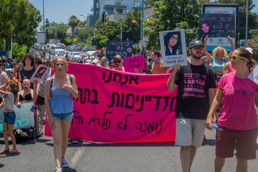 HAIFA, ISRAEL - JUNE 22, 2018: Various people take part and carry signs, in the annual pride parade of the LGBT community, in Haifa, Israel