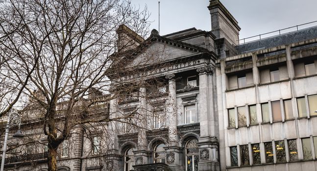 Dublin, Ireland - February 11, 2019: Architectural detail and street atmosphere in front of the Ulster Bank Commercial Bank building in the historic city center on a winter day