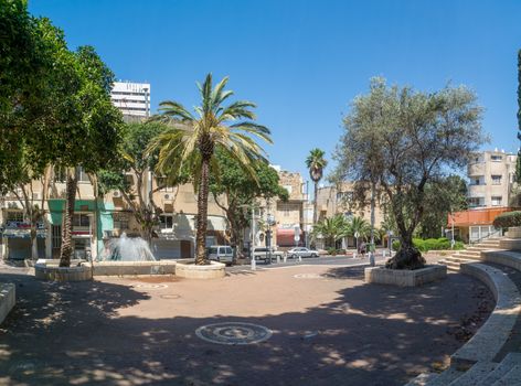 HAIFA, ISRAEL - JUNE 09, 2018: The Binyamin garden, fountain and Nordau street, with locals, in Hadar HaCarmel neighborhood, Haifa, Israel
