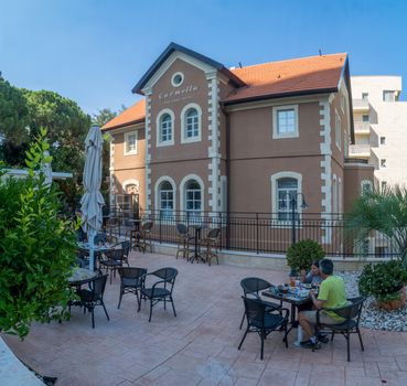 HAIFA, ISRAEL - JUNE 15, 2018: The Pastor Schneider House, now a hotel, with visitors, in Haifa, Israel