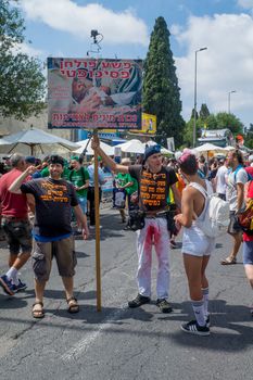 HAIFA, ISRAEL - JUNE 22, 2018: Protestors against circumcision, and other participants, take part in the annual pride parade of the LGBT community, in Haifa, Israel