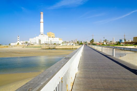 TEL-AVIV, ISRAEL - NOVEMBER 24, 2016: View of the Wauchope Bridge over the Yarkon stream, the Reading Power Station, a lighthouse, and visitors, in Tel-Aviv, Israel