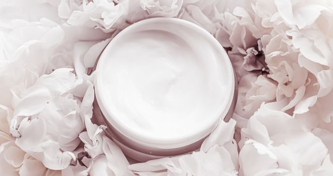 Luxe cosmetic cream jar as antiaging skincare routine product on background of peony flowers, body moisturizer and beauty branding design