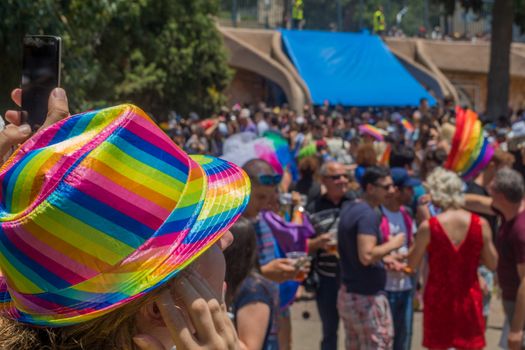 HAIFA, ISRAEL - JUNE 22, 2018: Hat in the rainbow colors, and crowd, in the annual pride parade of the LGBT community, in Haifa, Israel