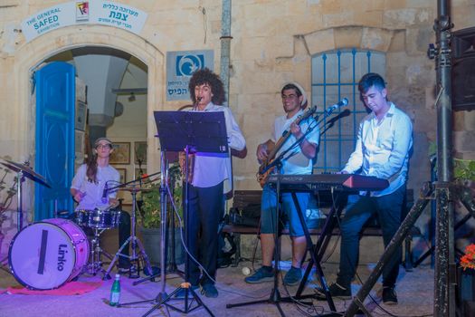Safed, Israel - August 14, 2018: Scene of the Klezmer Festival, with street musicians playing, in Safed (Tzfat), Israel. Its the 31st annual traditional Jewish festival in the public streets of Safed