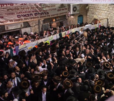 MERON, ISRAEL - MAY 18, 2014: Orthodox Jews dance at the annual hillulah of Rabbi Shimon Bar Yochai, in Meron, on Lag BaOmer Holiday. This is an annual celebration at the tomb of Rabbi Shimon